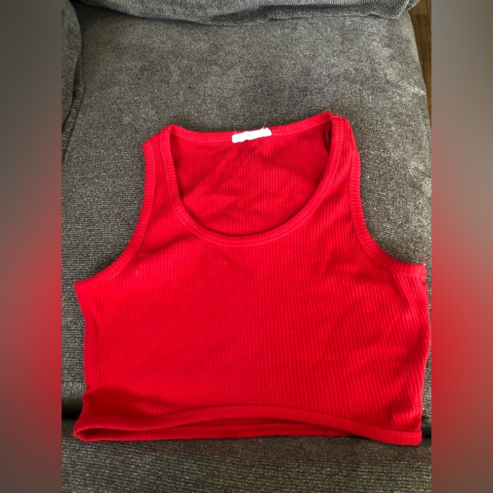 Red top, size M. Heart Hips brand, has a not very visible stain